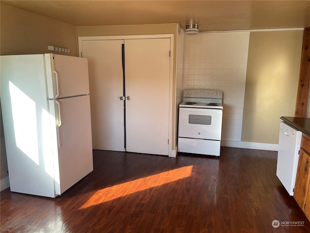 kitchen featuring white appliances and dark hardwood / wood-style flooring