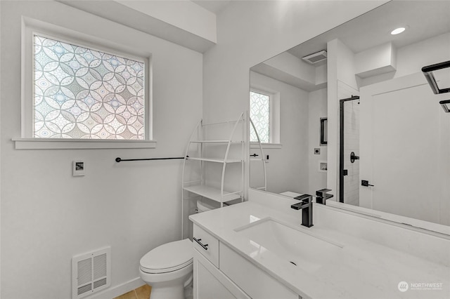 bathroom featuring toilet and vanity