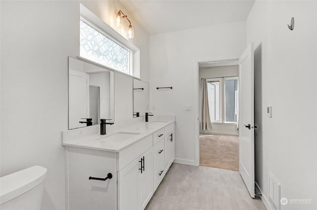 bathroom featuring toilet and vanity