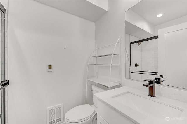 bathroom featuring walk in shower, vanity, and toilet