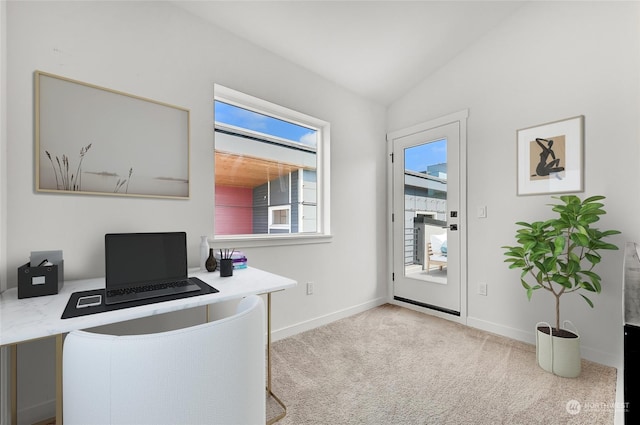 carpeted office space featuring vaulted ceiling