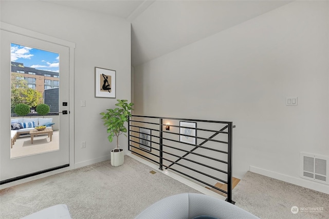 entryway featuring lofted ceiling and carpet flooring