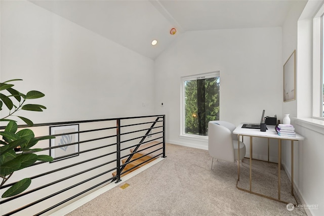 carpeted office featuring vaulted ceiling