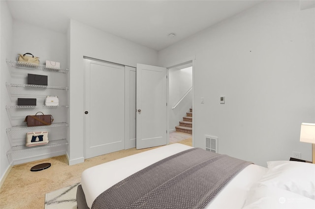 carpeted bedroom with a closet