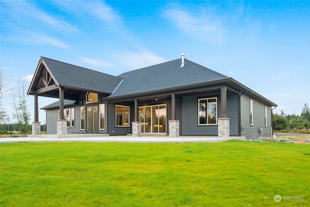 rear view of house featuring a lawn