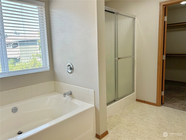 bathroom featuring separate shower and tub