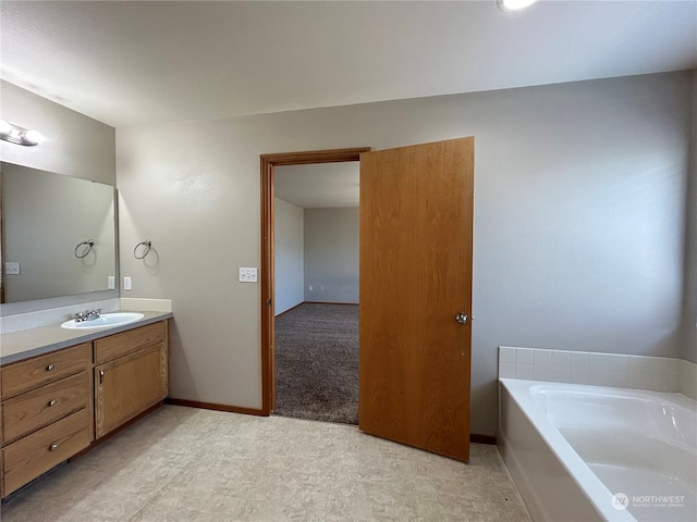 bathroom featuring a tub to relax in and vanity