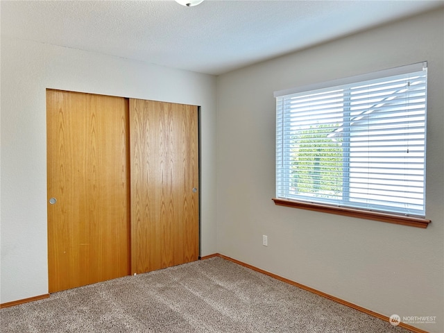 unfurnished bedroom with a closet and carpet