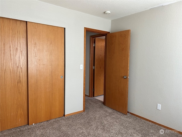 unfurnished bedroom featuring a closet and carpet floors