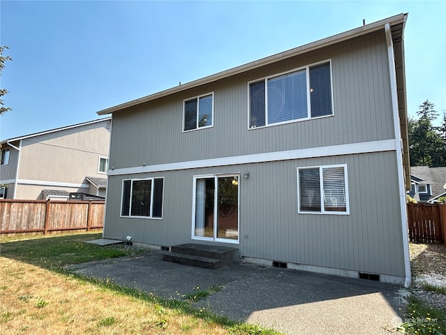 rear view of house with a yard