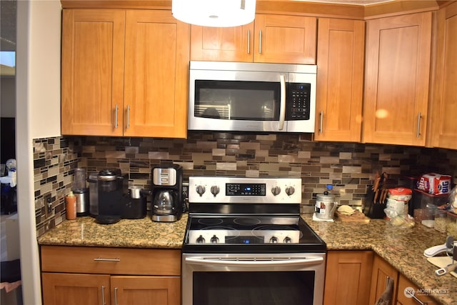 kitchen with backsplash, stainless steel appliances, and stone countertops