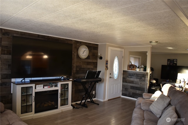 living room featuring hardwood / wood-style floors, a fireplace, and a textured ceiling