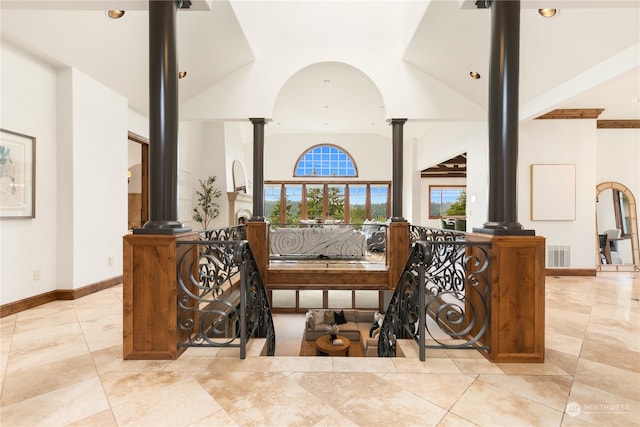 interior space with a towering ceiling and decorative columns