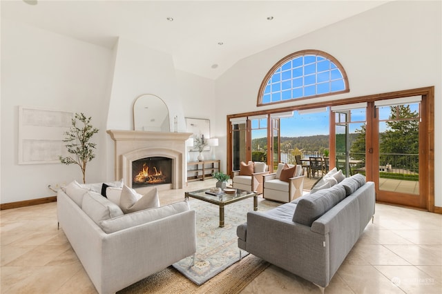 tiled living room with high vaulted ceiling and plenty of natural light