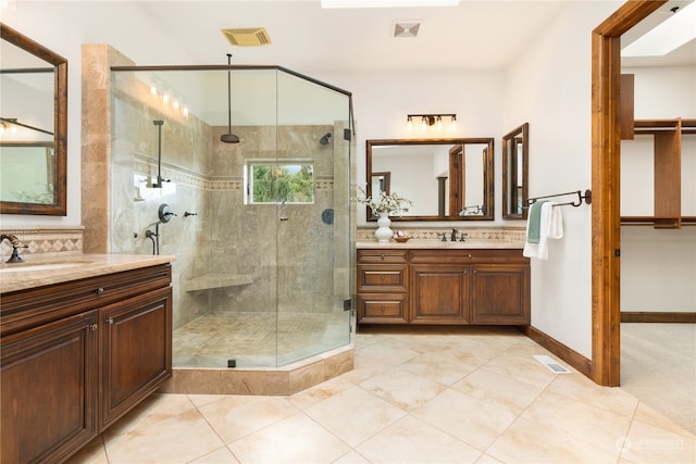 bathroom featuring vanity, tile patterned floors, and walk in shower