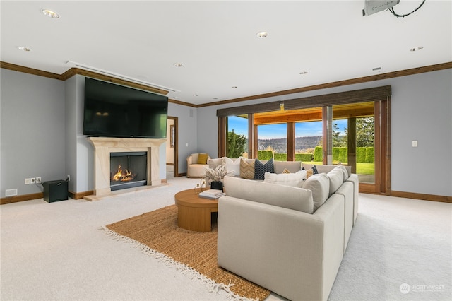 carpeted living room featuring crown molding and a fireplace