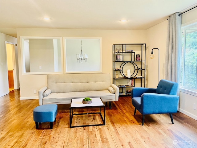 living room featuring hardwood / wood-style flooring, plenty of natural light, and a chandelier