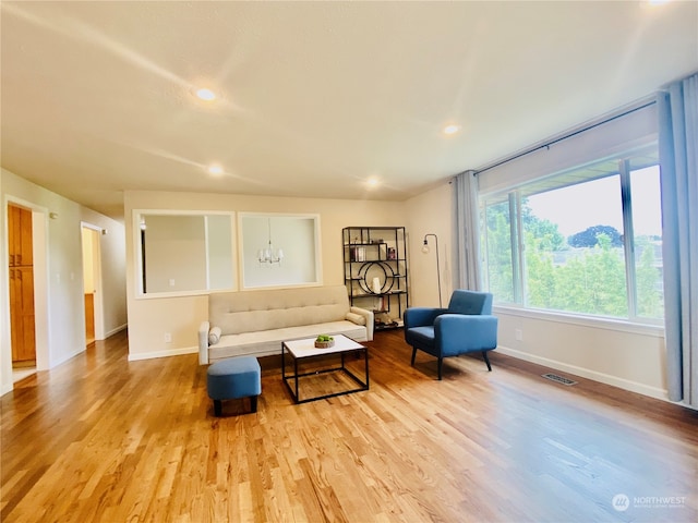 living room featuring light hardwood / wood-style flooring and a chandelier