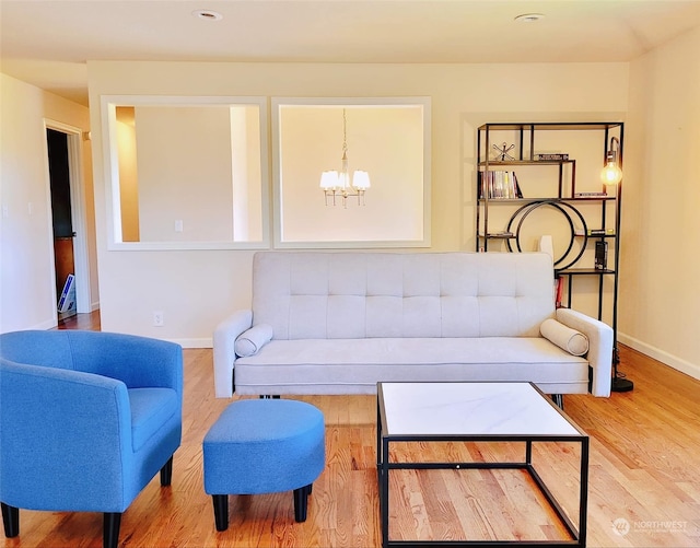 living room featuring wood-type flooring and a chandelier