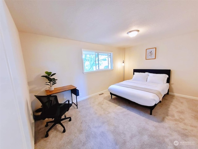 bedroom featuring light carpet