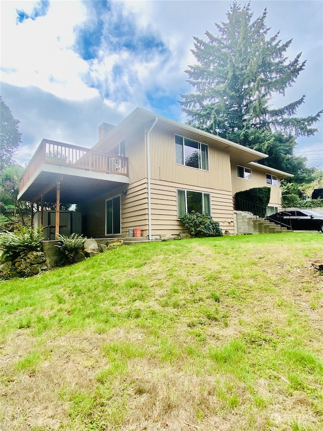 rear view of property with a lawn