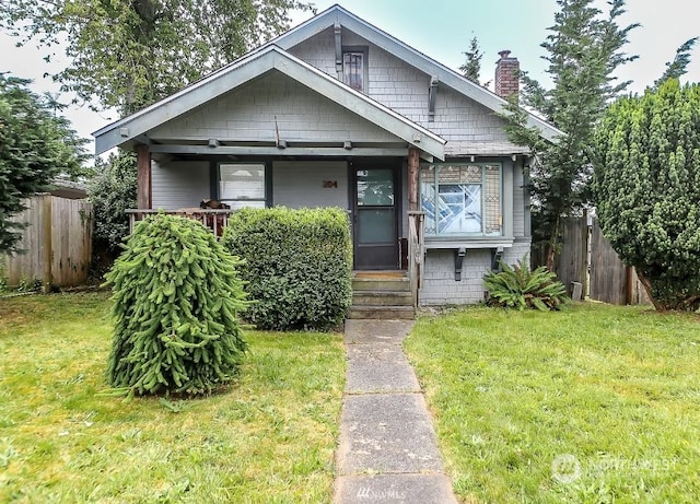 bungalow-style home featuring a front yard