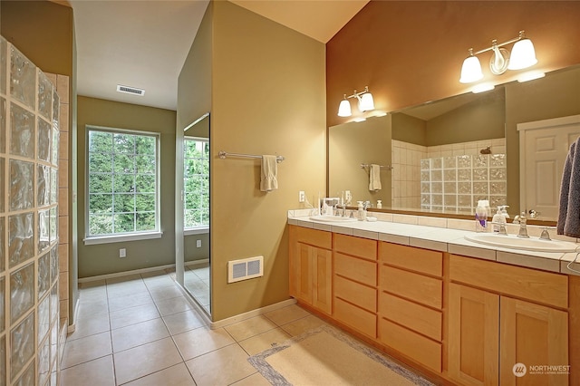 bathroom featuring lofted ceiling, tile patterned flooring, and vanity