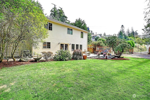 back of house featuring a patio area, a yard, and fence