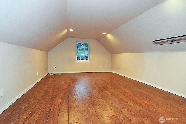 additional living space with recessed lighting, lofted ceiling, and wood-type flooring