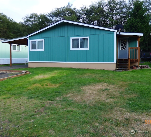 view of front facade featuring a front lawn and a carport