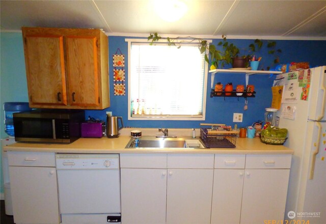 kitchen with white cabinets, white appliances, and sink