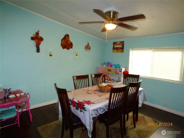 dining space featuring ornamental molding, dark wood-type flooring, lofted ceiling, and ceiling fan