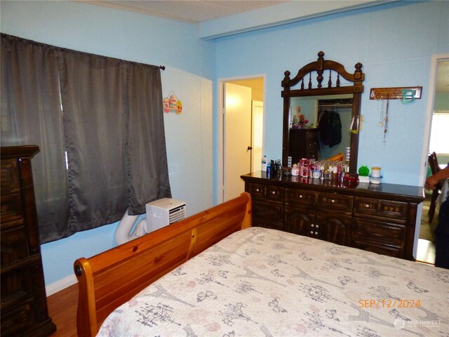 bedroom with wood-type flooring and a closet