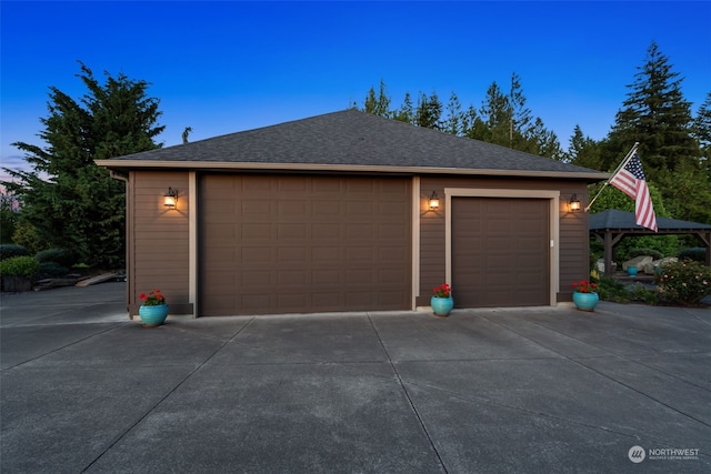 view of garage at dusk