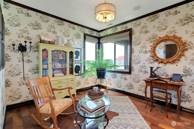 living area featuring ornamental molding, wood-type flooring, and a notable chandelier