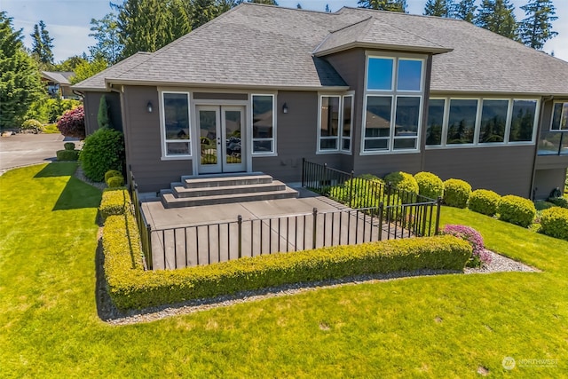 rear view of property featuring french doors and a yard