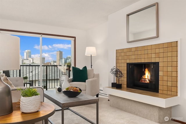 carpeted living room with a tile fireplace