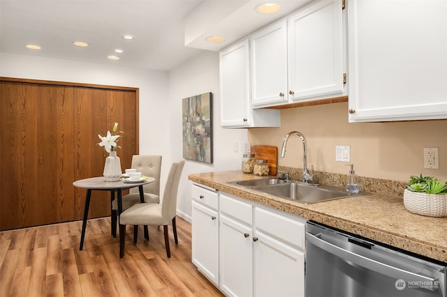 kitchen with stainless steel dishwasher, sink, light hardwood / wood-style flooring, and white cabinetry