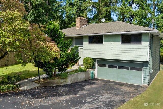 view of front of property with a garage and a front yard