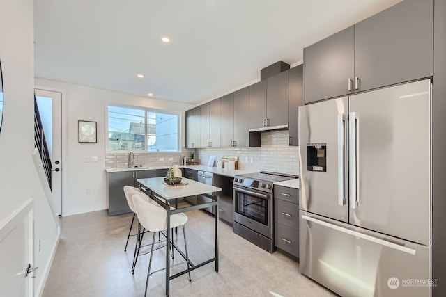 kitchen with decorative backsplash, appliances with stainless steel finishes, gray cabinets, and sink