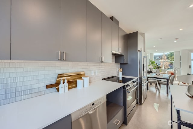 kitchen with appliances with stainless steel finishes, decorative backsplash, and gray cabinetry