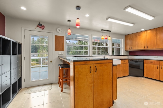 kitchen with pendant lighting, light tile patterned flooring, kitchen peninsula, dishwasher, and a kitchen breakfast bar