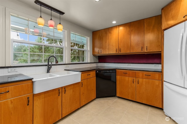 kitchen with hanging light fixtures, dishwasher, light tile patterned floors, white fridge, and sink