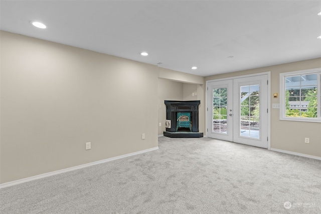 unfurnished living room with french doors and carpet