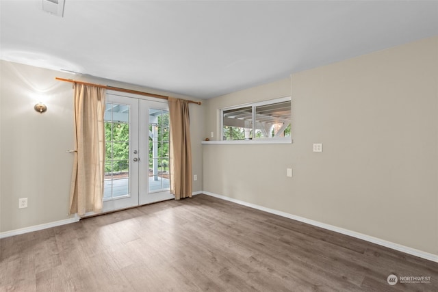 unfurnished room with french doors and wood-type flooring