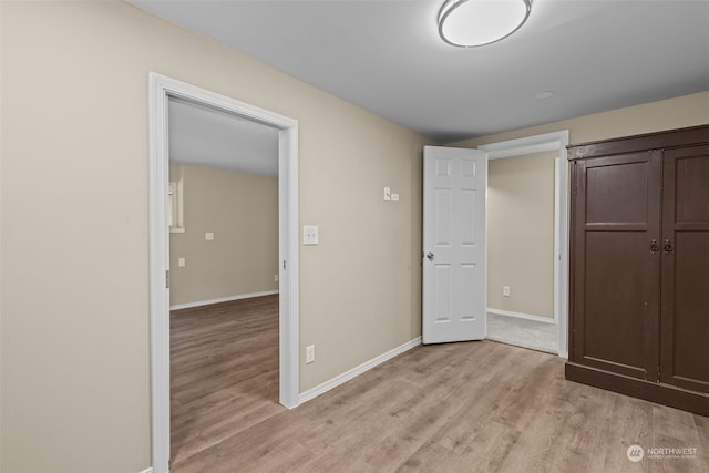 unfurnished bedroom featuring a closet and light hardwood / wood-style floors