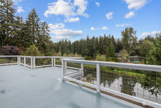 view of patio / terrace with a balcony and a water view