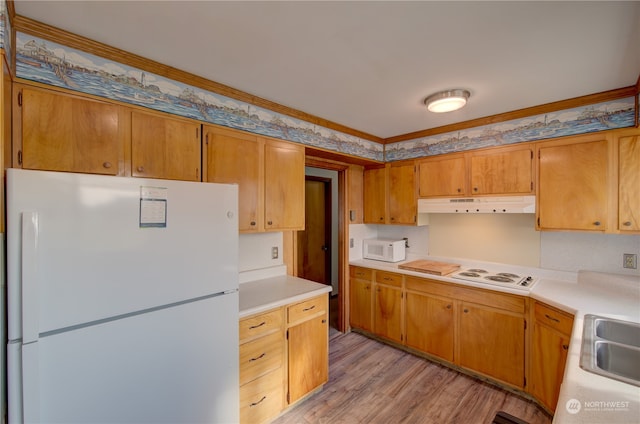 kitchen featuring light wood-type flooring, white appliances, and ornamental molding