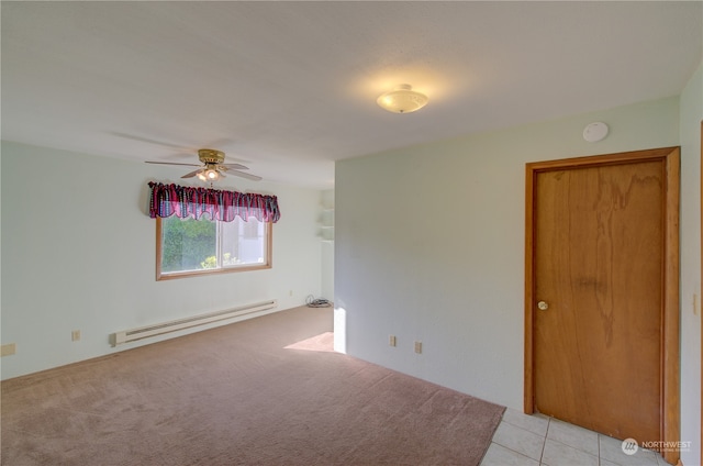 carpeted empty room with a baseboard radiator and ceiling fan