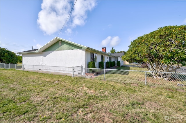 view of side of home featuring a yard